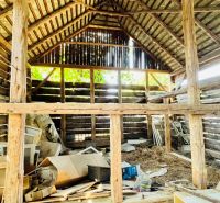 The interior of an older wooden family house with clutter and building materials.