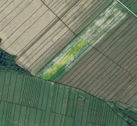 Aerial view of agricultural and forest lands in Plaveč with fields of various sizes.