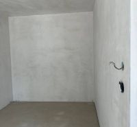 Unfurnished room with bare walls in a 2-room apartment.