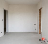 Bedroom in a 2-room apartment with a bed, window, and floor with wood decor.
