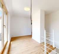A room with white walls and a wooden decor floor in a 5 or more room apartment.