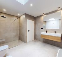 A bathroom in a 5 or more room apartment with a large mirror and a shower corner.