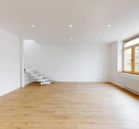 A spacious room with a wood-patterned floor and a large window, 5 or more bedroom apartment.