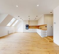 A spacious kitchen with a wooden decor floor in a 5 or more room apartment.