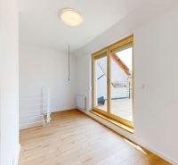A room in a 5 or more bedroom apartment with a wood-patterned floor and a terrace.