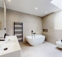 A bathroom in a 5 or more room apartment with a freestanding bathtub and two sinks.