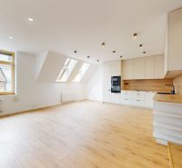 Spacious kitchen with wood-patterned flooring in a 5 or more room apartment.