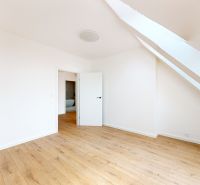 A room in a 5 or more bedroom apartment with white walls and a wooden decor floor.