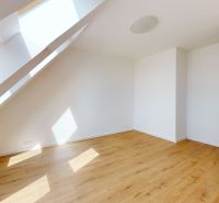 A bright room with a wood-patterned floor in a 5 or more room apartment.
