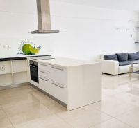 A spacious kitchen connected to the living room, light tones, and stylish graphic details.
