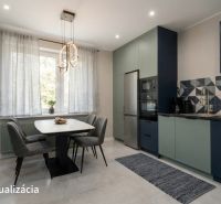 A kitchen in a studio apartment with a dining table, curtains, and built-in appliances.