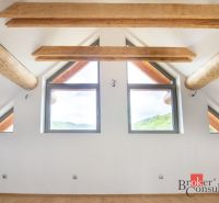 Interior of a family house with ceiling beams and a floor with a wood decor.