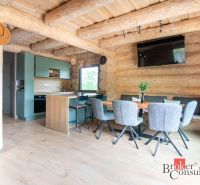 A cozy kitchen in a family house with a wooden decor floor and wooden walls.