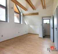 Attic room in a family house with wooden beams and a wooden decor floor.