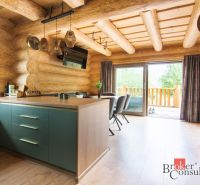 Interior of a family house with wooden decor and a kitchen island.