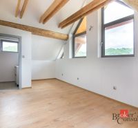 A floor with a wooden decor and beams in the attic room of a family house.