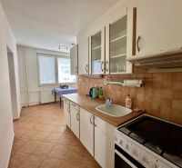 A kitchen in a 4-room apartment with tiles and a worktop.