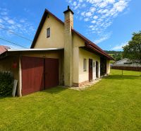 A family house in Oščadnica has a gable roof, a lawn, and an extension on the street in Oščadnica.