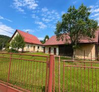 A family house in Oščadnica on Oščadnica street with a red roof and a large garden.