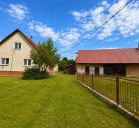 A family house in Oščadnica on Oščadnica Street with a spacious garden and a farm building.