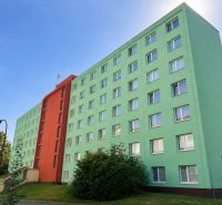A colorful apartment building on Školská Street in Banská Bystrica with a blue sky.