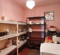 A pantry in a family house with shelves for food and accessories.