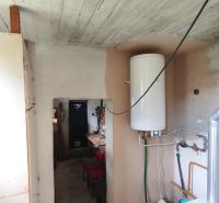 Bathroom in a family house with a boiler and a boiler room, tiled floor.