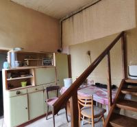 Staircase and older furniture in a family house with wooden decor on the floor.