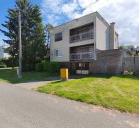 A family house in Nenince with a garden, garage, and balcony, on a quiet street.