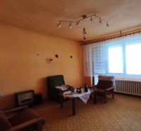 Living room in a family house with orange walls and vintage furniture.