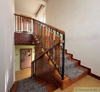 Staircase in a family house, wooden railing, carpet on the stairs, brick cladding.