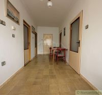 Hallway in a family house with pictures and a kitchen table.