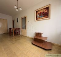 Dining room in a family house with a painting, floor, table, and chairs.