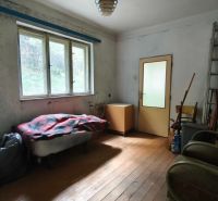 A room in a family house with light, old furniture, and a floor with a wooden decor.