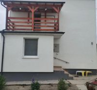 A family house in Bratislava with a balcony and a small garden in a simple style.