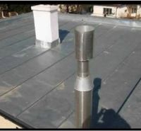 The flat roof of a family house in the town of Soľ shows the chimney and ventilation system.