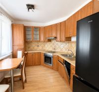Kitchen in a 3-room apartment with a wooden decor countertop and floor, swivel table.