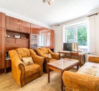 Living room in a family house with furniture and flooring featuring a wood design.