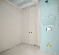 A construction room in a 3-room apartment with preparation for sanitary installation.