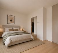 A bedroom in a 3-room apartment with a large bed and a floor with a wooden decor.