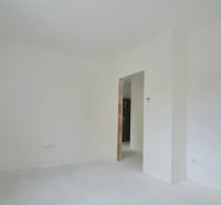 A bright room with white walls and floor in a 3-room apartment.