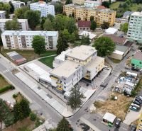 A view of the residential street Školská in Hriňová with 3-room apartments and green areas.