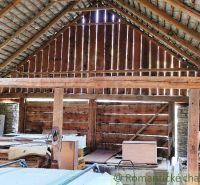 Wooden interior structure, suitable for residential plots, with stored materials.