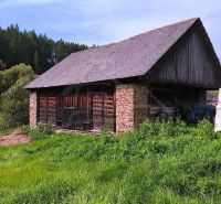 A wooden barn surrounded by greenery on a plot in Nižné Repaše.