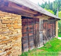 A wooden structure with a stone wall on a plot in Nižné Repaše, suitable for living.