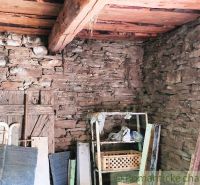 Stone walls and a wooden ceiling in the room on the grounds - living space.
