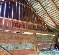 Interior of the property - living space with wooden boards, exposed roof structure.