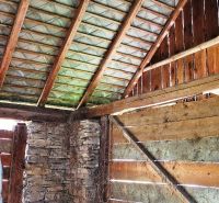 Wooden interior with a stone wall in a house on the property - living.