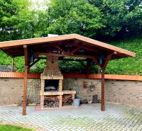 A gazebo with a brick fireplace in the garden of a family house in Mikušovce.