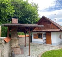 A family house in Mikušovce with a garden shelter and a brick chimney.